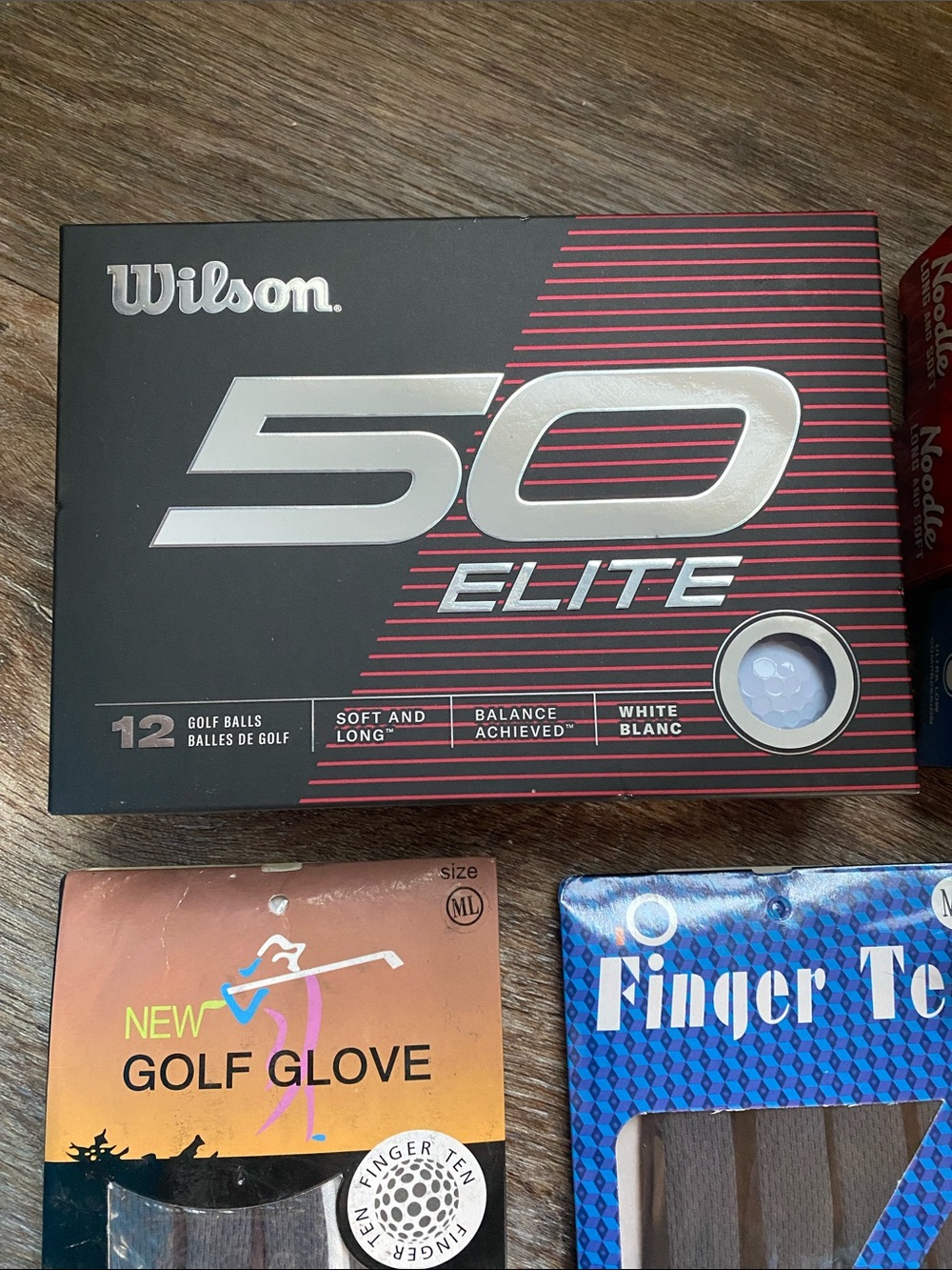 Golf bundle of NIB Wilson Elite balls, new gloves, bamboo tees, 54 used balls